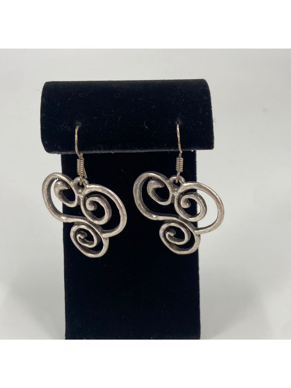 Silver tone swirl trinity earrings